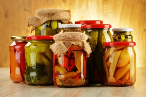 Composition with jars of pickled vegetables. Marinated food